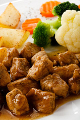 Goulash with roasted potatoes and vegetables