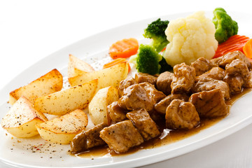 Goulash with roasted potatoes and vegetables