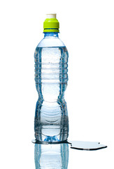 bottle of water with puddle besides