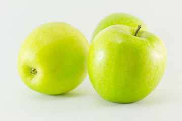 Three green apples isolated on white background