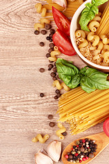 spaghetti with garlic, onion, spices  and basil on a yellow back