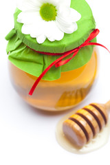 stick to hohey ,flower  and  jar of honey  isolated on white