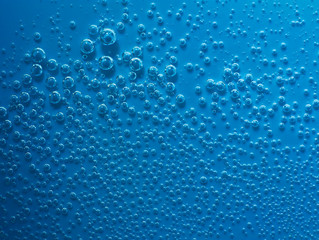 Naklejka na ściany i meble Small cyan abstract water with bubbles. Macro. Closeup.