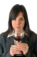 young brown woman smelling a glass of red wine