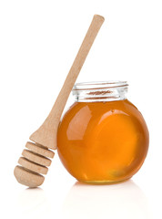 pot of honey and stick on white