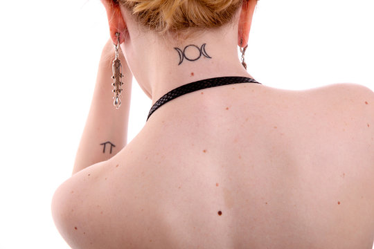 Woman With Moon Rune Tattoo On Neck And  Wind Rune On Arm