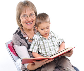 Grandmother and grandson reading a book