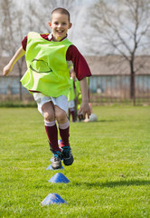 boy jumping on the soccer field