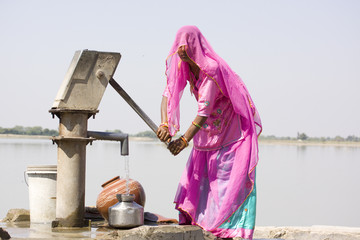 woman filling drinking water, rural Rajasthan , India