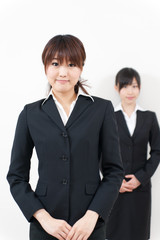 two asian businesswomen standing