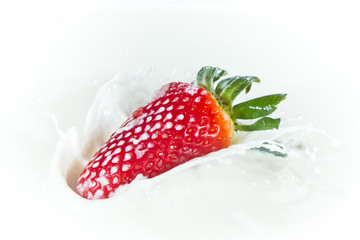 strawberry splashing into milk