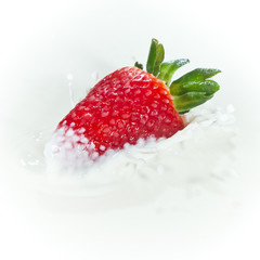 strawberry splashing into milk