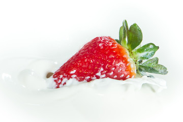 strawberry splashing into milk