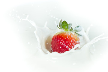 strawberry splashing into milk