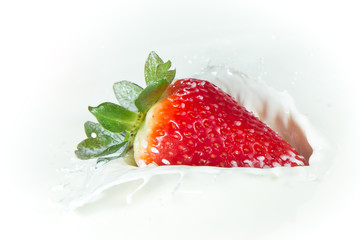 strawberry splashing into milk