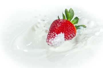 strawberry splashing into milk