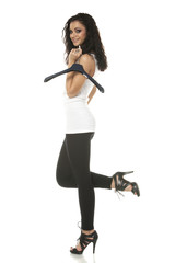 Naklejka premium Young woman holding clothes hanger on finger looking at camera