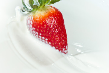 strawberry splashing into milk