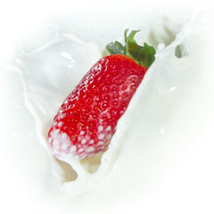 strawberry splashing into milk