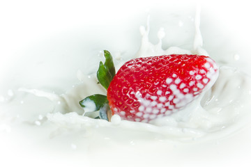 strawberry splashing into milk