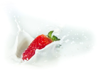 strawberry splashing into milk