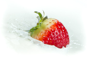 strawberry splashing into milk