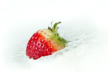 strawberry splashing into milk