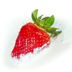 strawberry splashing into milk