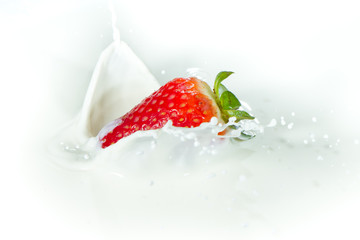 strawberry splashing into milk