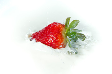 strawberry splashing into milk