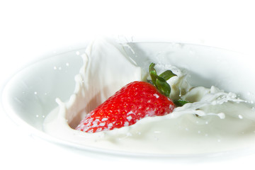 strawberry splashing into milk