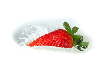 strawberry splashing into milk