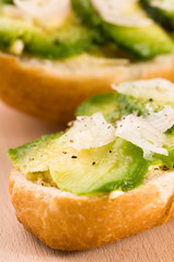 Sandwich with avocado on a wooden board