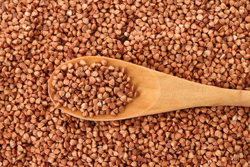 wooden spoon on Buckwheat background