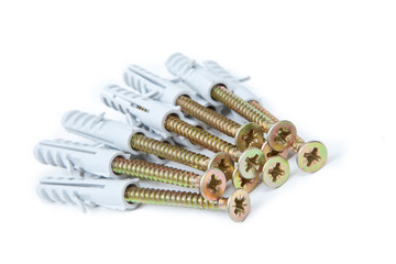 Fototapeta premium Brass screw with grey plastic anchor isolated