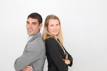 Business people standong back to back on grey background