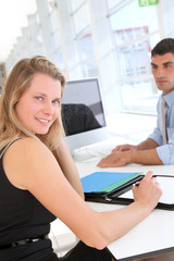 Woman in office signing contract