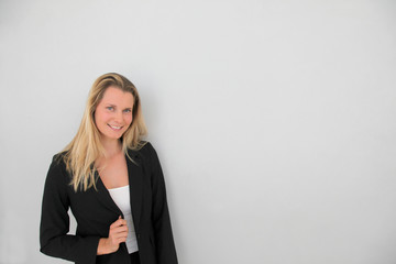 Beautiful businesswoman standing on grey background