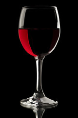 Elegant red wine glass in a black background