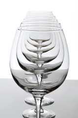 Six empty wine glasses lined