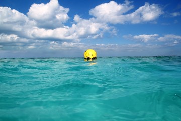Fototapeta na wymiar Buoy yellow floating in tropical Caribbean sea