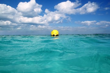 Obraz premium Buoy yellow floating in tropical Caribbean sea
