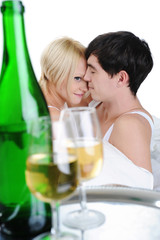 Young couple drinking champagne in bed