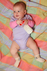 Little baby girl holding milk bottle