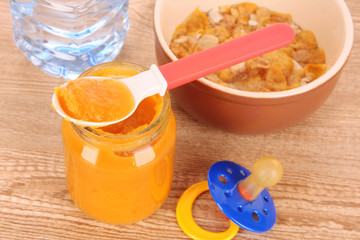 food for children and spoon on brown background