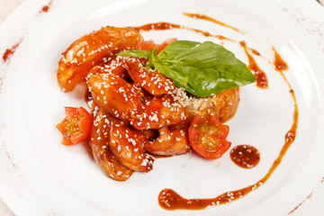 portion of sesame chicken served on a white plate