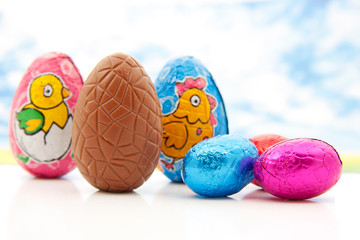 Colorful chocolate easter eggs over white background