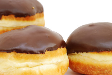 Close-up of chocolate donuts on white background