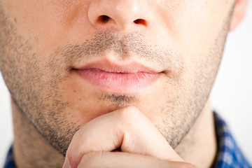 Obraz premium Closeup of a young thoughtful man's lips and chin