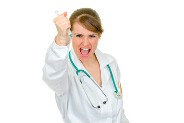 Aggressive doctor woman brandishing medical syringe